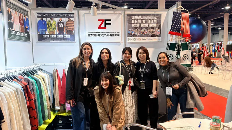 International buyers visiting Yifang International Trading knitwear manufacturer booth at apparel sourcing trade show